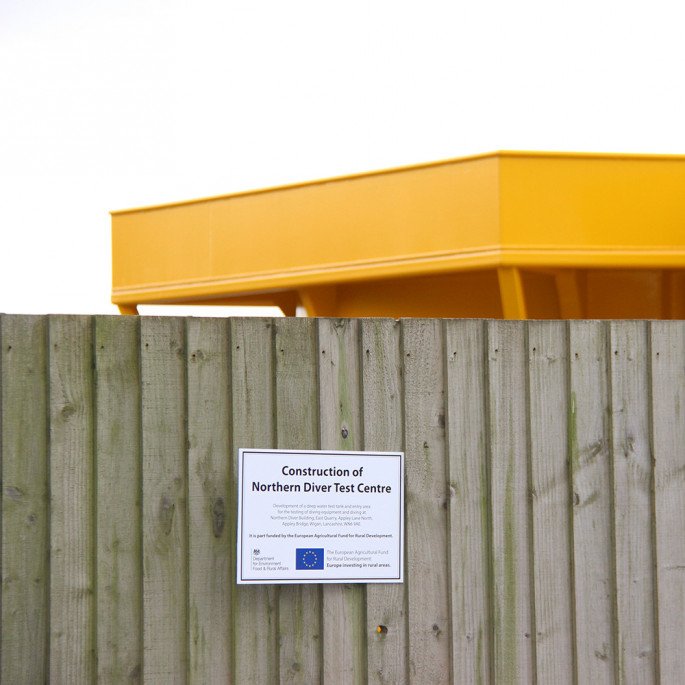 Northern Diver Diving Test Tank: EU funding plaque, outside on our wooden fence
