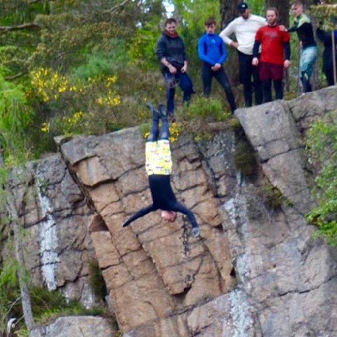 Chris Murphy in his cliff jump descent, wearing his Northern Diver gloves and wetsuit