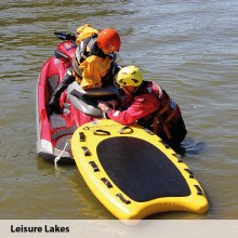 A lifeboard demo day at Leisure Lakes with users wearing our storm water rescue surface suits